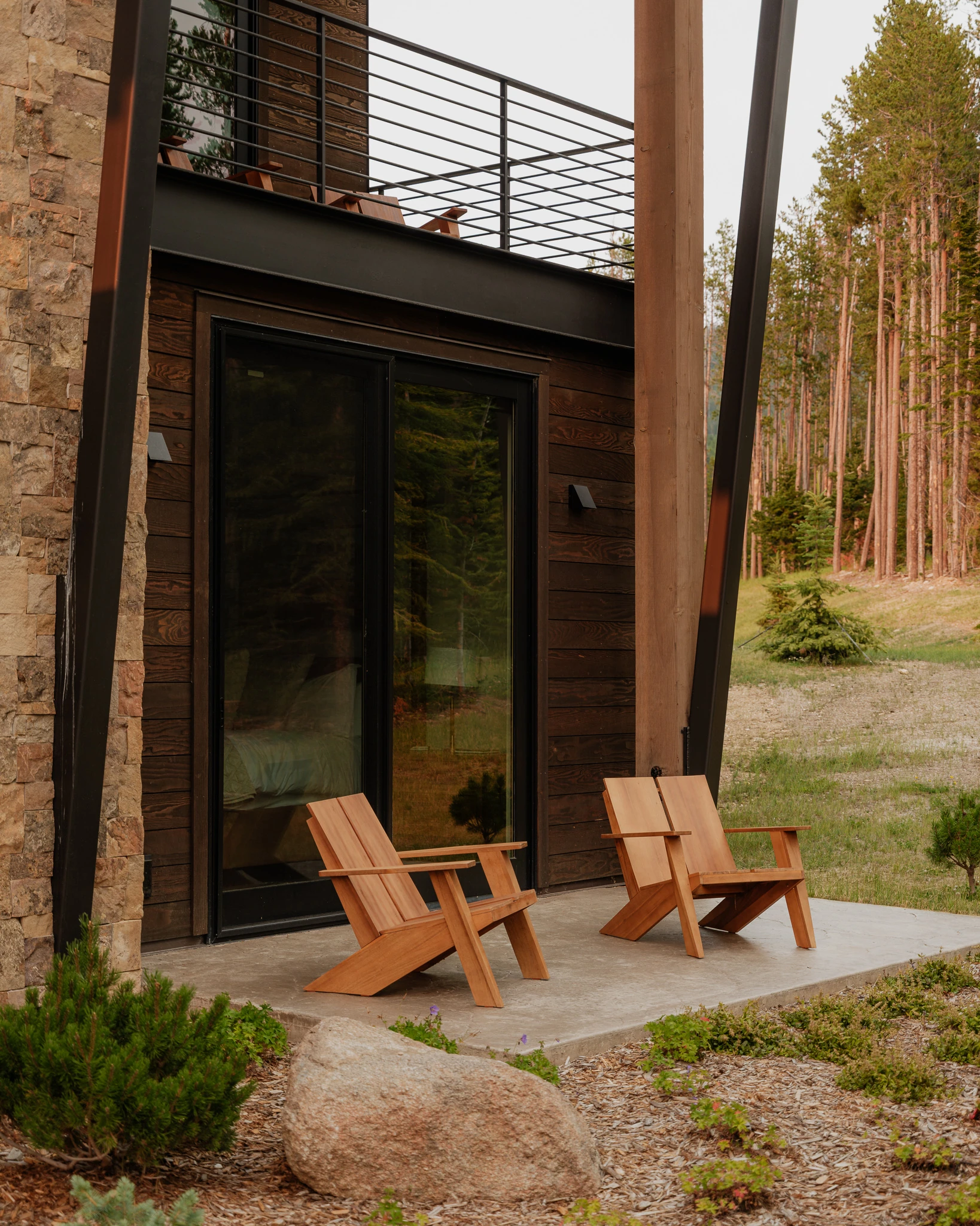 Exterior patio beneath the upper balcony — architectural photography Big Sky Montana, Reid Smith Architects